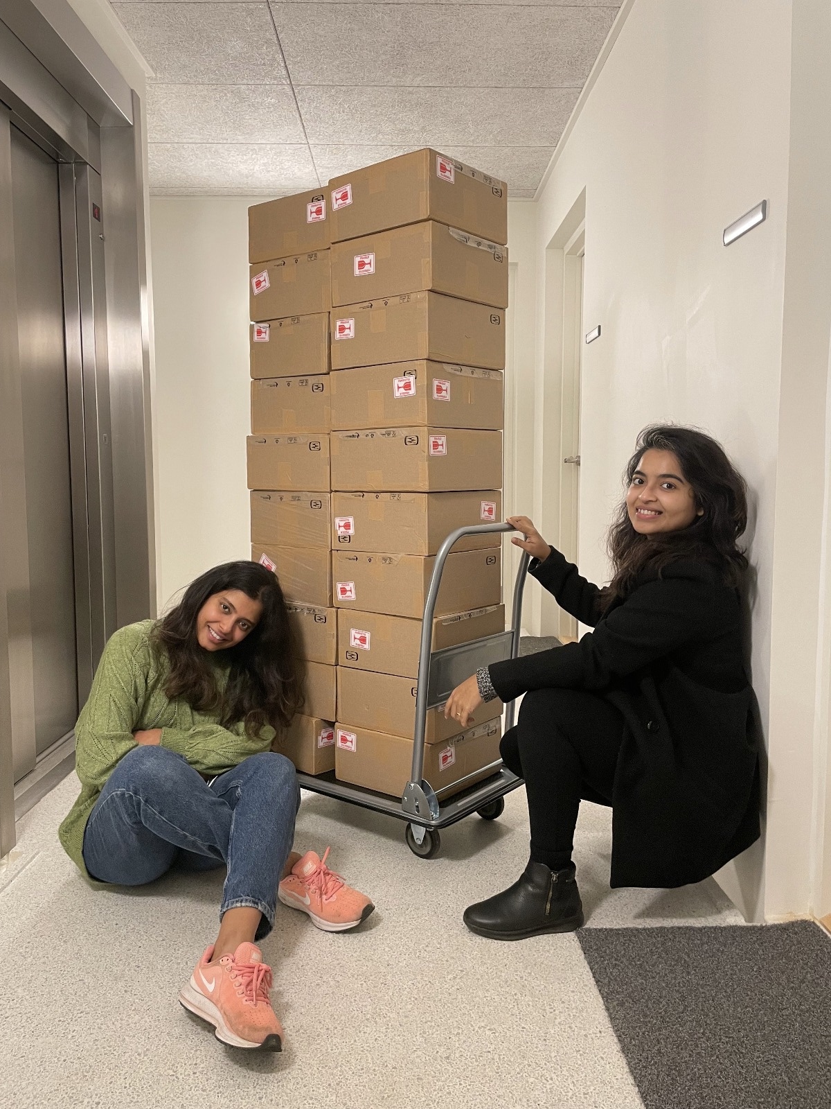 The Lush Box founders with stacked shipping boxes ready for dispatch.